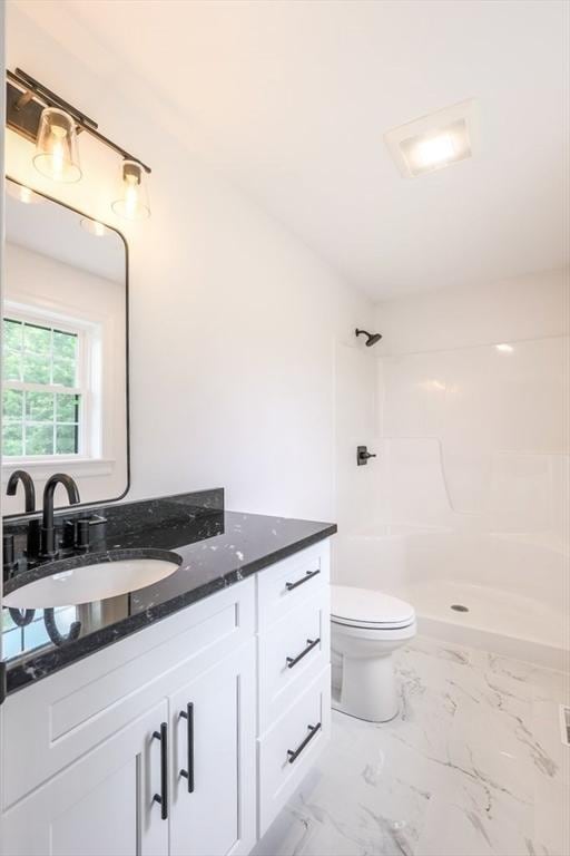 40 Jackson Ln, Barre, MA 01005 - full bath with marble look tile flooring, vanity, toilet, and a shower