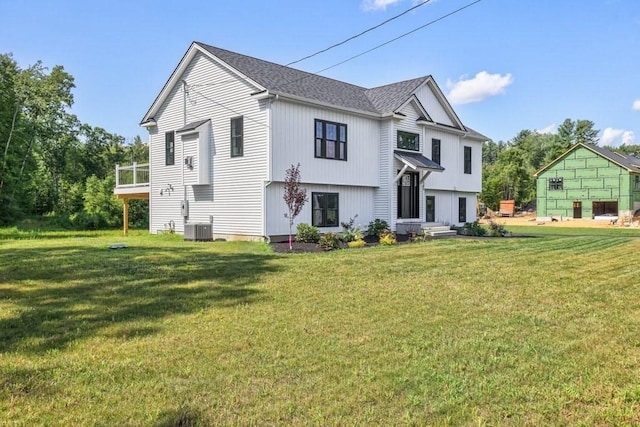 40 Jackson Ln, Barre, MA 01005 - rear view of house with central AC unit and a lawn