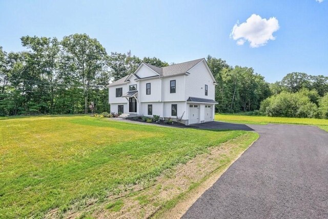 40 Jackson Ln, Barre, MA 01005 - view of front of home featuring driveway, a garage, and a front lawn
