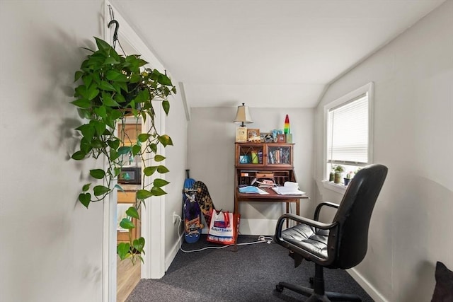 carpeted office featuring vaulted ceiling