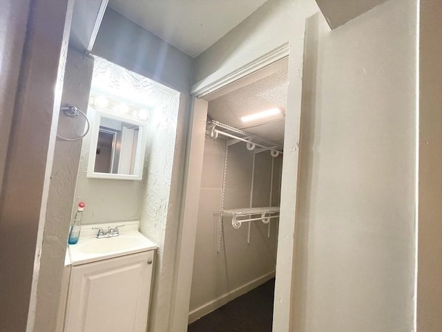 bathroom with vanity and a textured ceiling