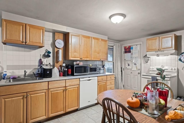 kitchen featuring light tile patterned floors, white appliances, backsplash, and sink