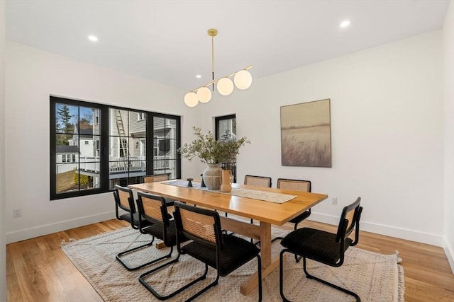 dining room with recessed lighting, light wood-style floors, and baseboards