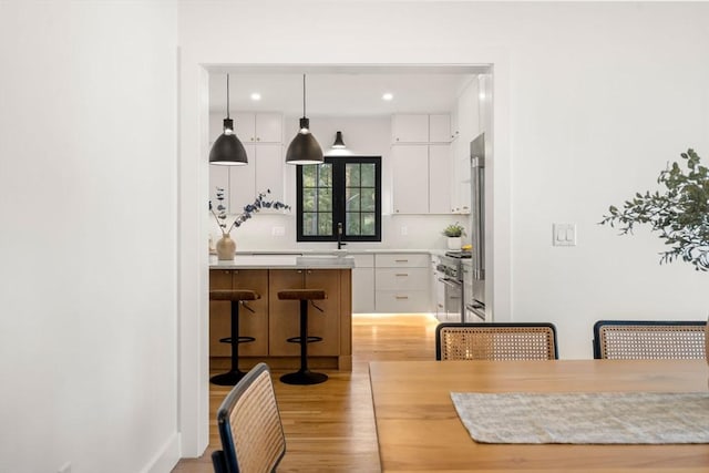 dining space featuring recessed lighting and light wood-style floors