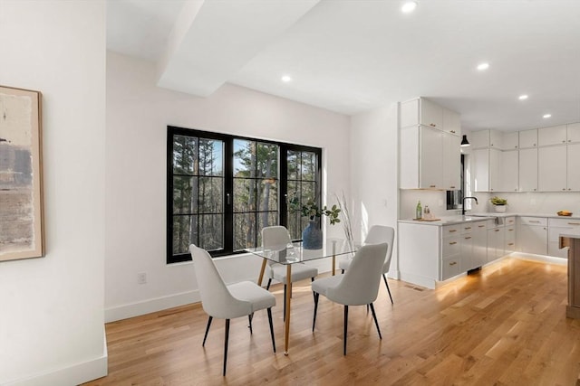 dining area with recessed lighting, baseboards, and light wood finished floors