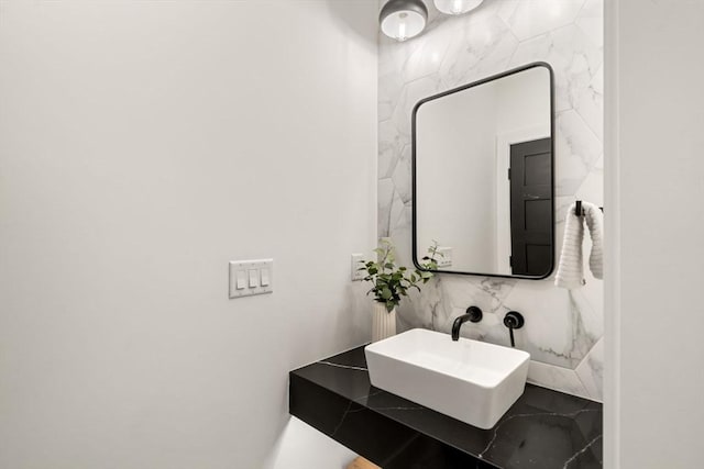 bathroom featuring tile walls and a sink