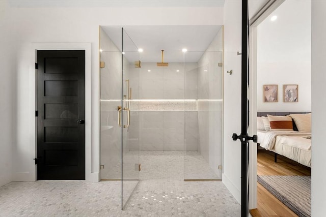 full bath with recessed lighting, wood finished floors, a stall shower, and ensuite bathroom