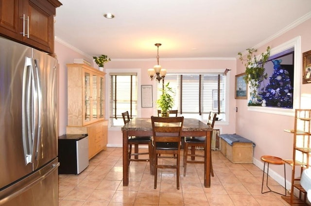 tiled dining area with a notable chandelier, ornamental molding, and radiator