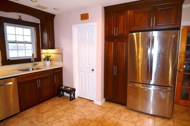 kitchen featuring sink, light tile patterned floors, and appliances with stainless steel finishes