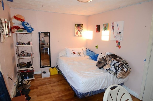 bedroom with dark wood-type flooring