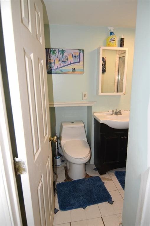 bathroom featuring toilet, tile patterned floors, and vanity