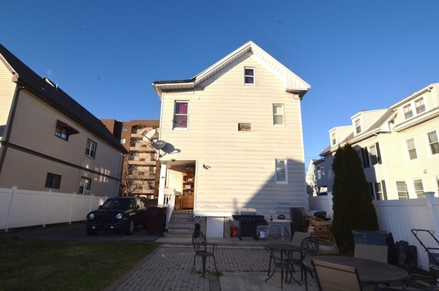 back of property with a patio