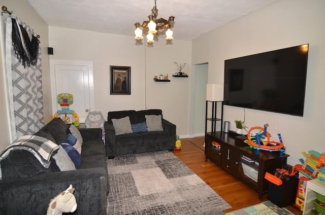 living room featuring a chandelier and hardwood / wood-style floors