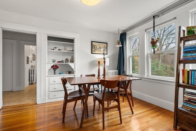 65-67 Westchester Rd, Newton, MA 02458 - dining area with light wood finished floors, baseboards, and radiator