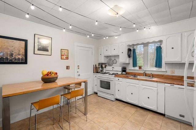 65-67 Westchester Rd, Newton, MA 02458 - kitchen with white cabinetry, wood counters, a sink, and white appliances
