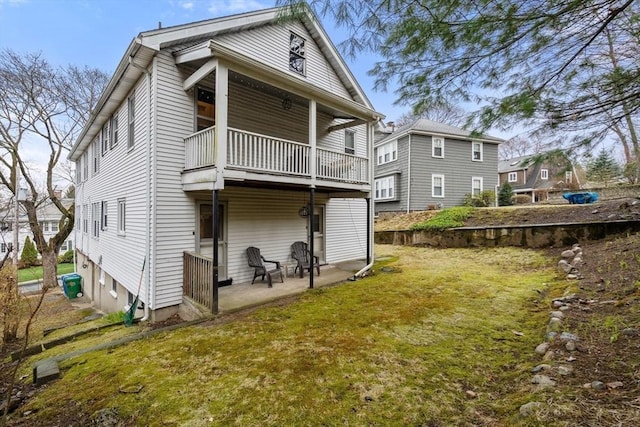 65-67 Westchester Rd, Newton, MA 02458 - rear view of house featuring a balcony, a patio area, and a lawn