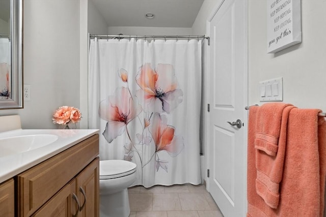 bathroom with curtained shower, vanity, toilet, and tile patterned floors