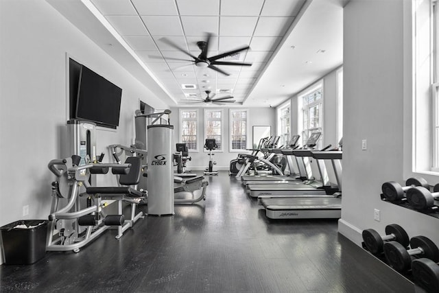 workout area with ceiling fan, baseboards, and wood finished floors