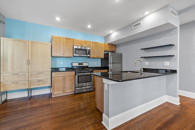 kitchen featuring sink, light brown cabinetry, stainless steel appliances, dark hardwood / wood-style flooring, and kitchen peninsula