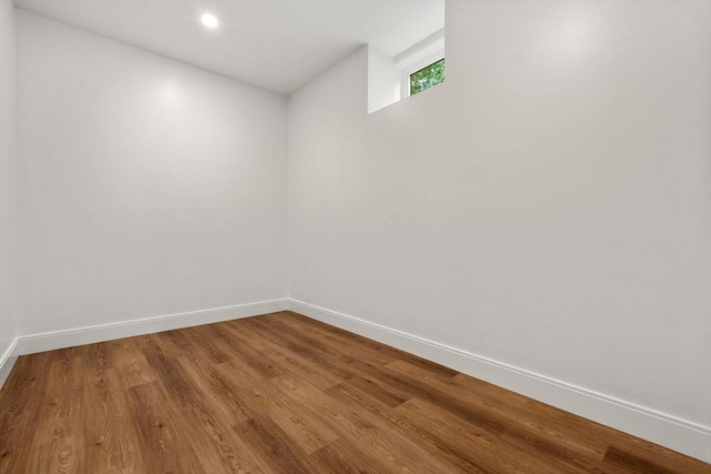 unfurnished room with wood-type flooring