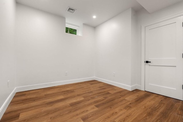 empty room with hardwood / wood-style flooring