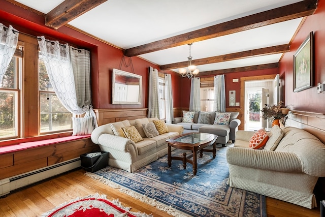 living room with wood-type flooring, a wealth of natural light, a chandelier, and beamed ceiling