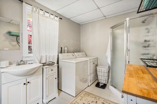 clothes washing area with sink and washer and dryer