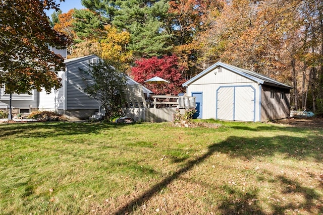 view of yard with a wooden deck and a storage shed