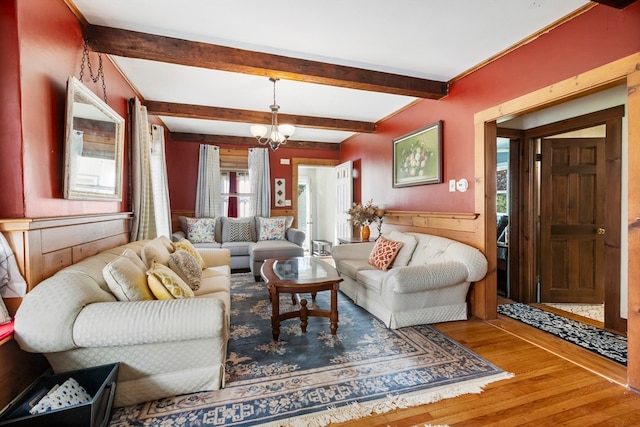 living room with beamed ceiling, a chandelier, and wood-type flooring