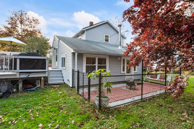 back of property with a patio and a yard