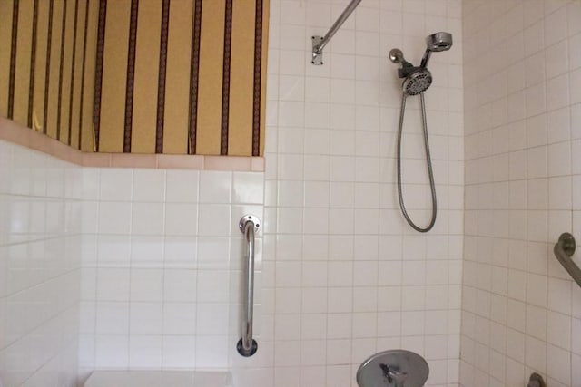 full bath with a tile shower