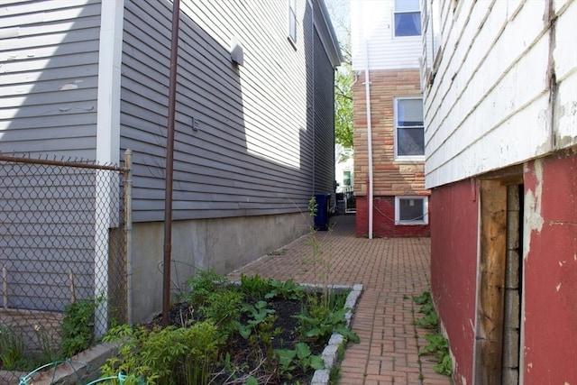 view of side of property featuring fence