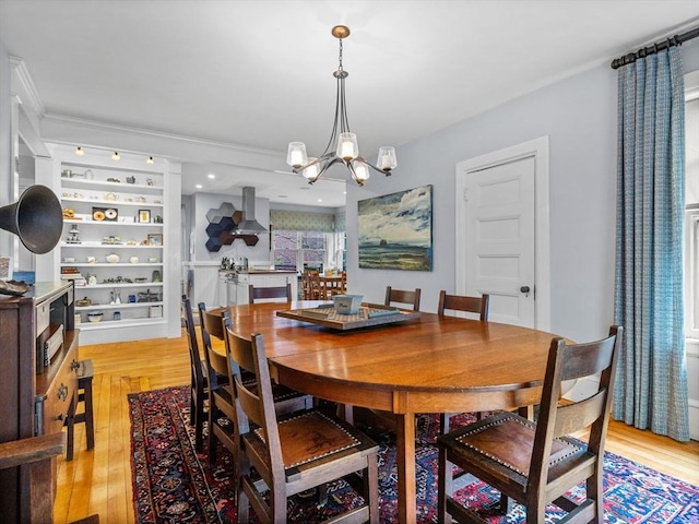 4 Greenough Ave, Boston, MA 02130 - dining space featuring a chandelier, light wood finished floors, and ornamental molding