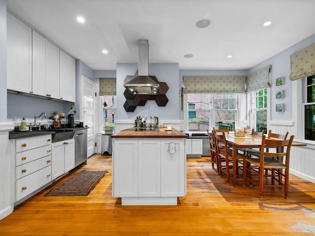 4 Greenough Ave, Boston, MA 02130 - kitchen featuring butcher block counters, dishwasher, white cabinetry, island exhaust hood, and wainscoting