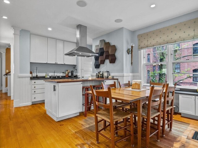 4 Greenough Ave, Boston, MA 02130 - kitchen with island range hood, wooden counters, recessed lighting, light wood-type flooring, and white cabinets