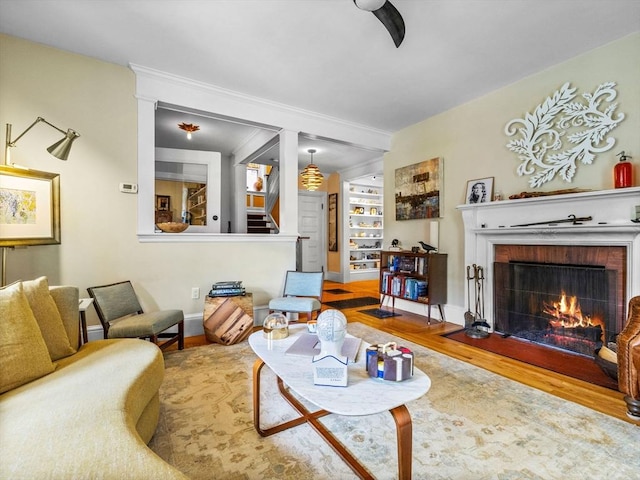 4 Greenough Ave, Boston, MA 02130 - living room with wood finished floors, a fireplace, stairway, baseboards, and ornamental molding