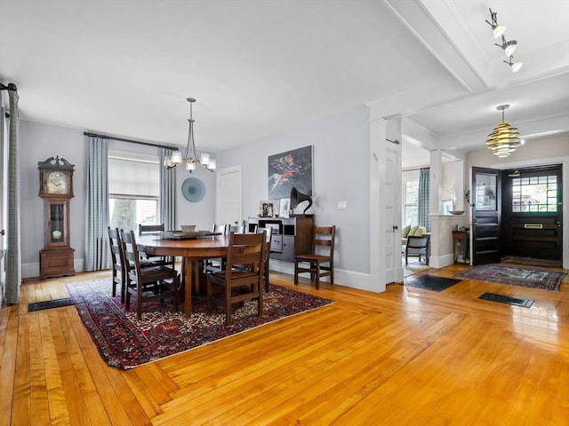 4 Greenough Ave, Boston, MA 02130 - dining space featuring a chandelier, wood-type flooring, and baseboards