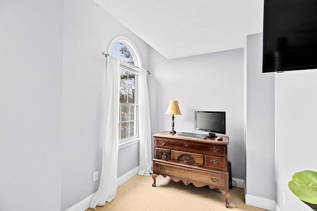 interior space with light carpet and vaulted ceiling