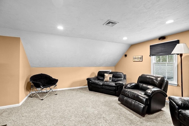 carpeted home theater featuring vaulted ceiling