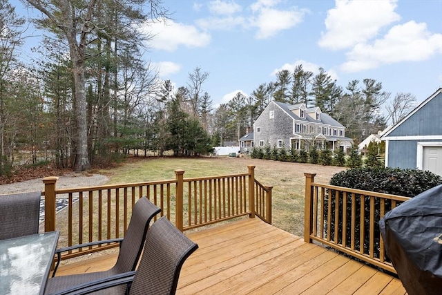 deck with grilling area and a lawn