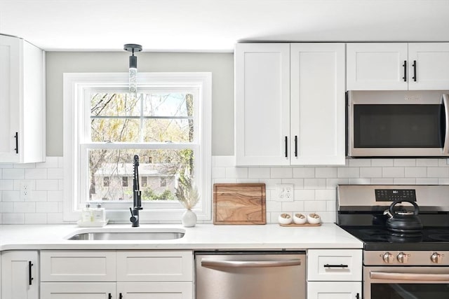 kitchen featuring a sink, white cabinetry, appliances with stainless steel finishes, and light countertops