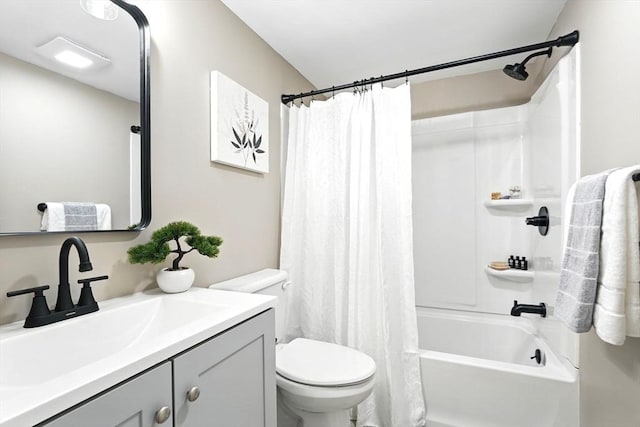 bathroom with vanity, shower / tub combo with curtain, and toilet