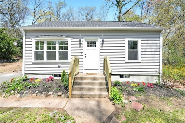 bungalow featuring a shingled roof