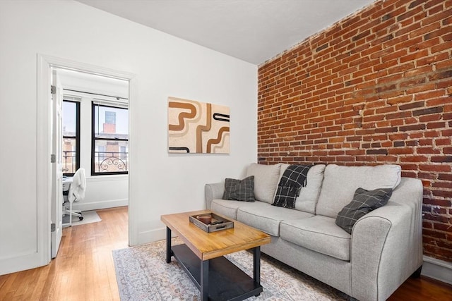 107 Jersey St Unit 16, Boston, MA 02215 - living room with baseboards, brick wall, and wood finished floors
