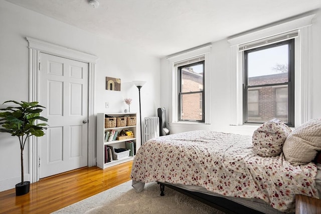 107 Jersey St Unit 16, Boston, MA 02215 - bedroom featuring radiator, wood finished floors, and access to exterior