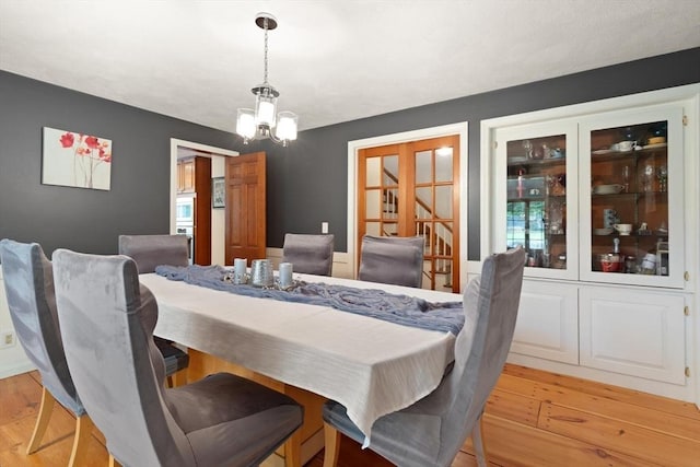 41B Washington St, Boxford, MA 01921 - dining area with a chandelier, light wood-style flooring, and french doors
