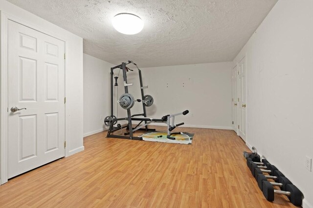 41B Washington St, Boxford, MA 01921 - exercise room with light wood-type flooring and a textured ceiling