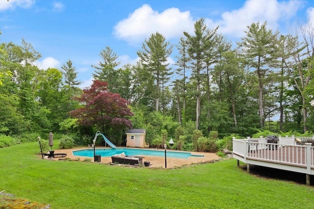 41B Washington St, Boxford, MA 01921 - swimming pool featuring a water slide, a storage unit, a wooden deck, and a yard