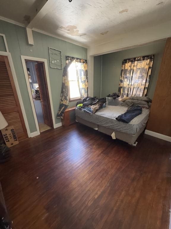 bedroom featuring wood finished floors and baseboards