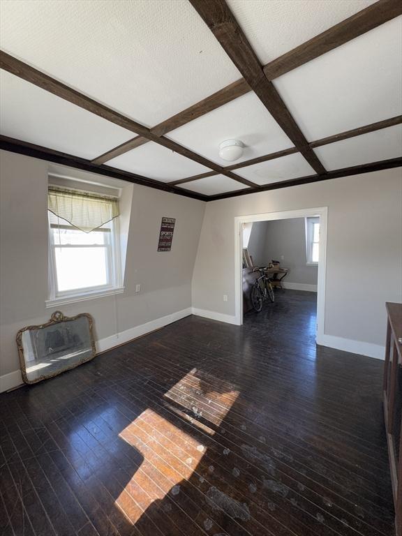 unfurnished room with hardwood / wood-style flooring, coffered ceiling, and a wealth of natural light